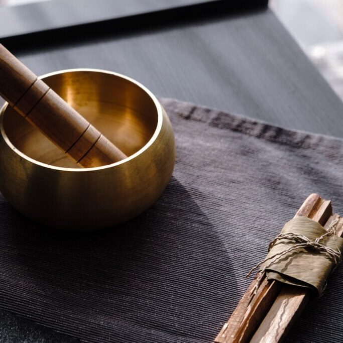 Bronze tibetan singing bowl with wooden stick, palo santo wood. Sound healing, sound bath therapy